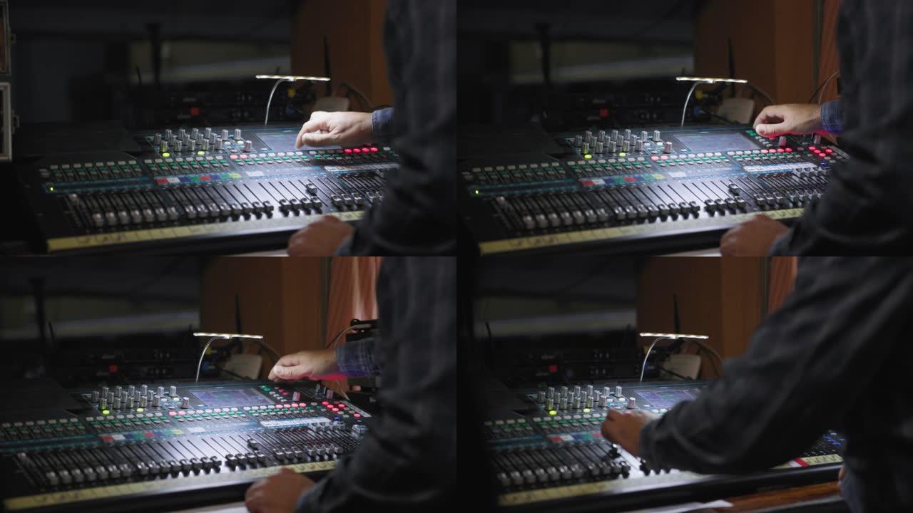广播电台，录音师之手在制作工作室中使用带有编辑工具的音乐混音器