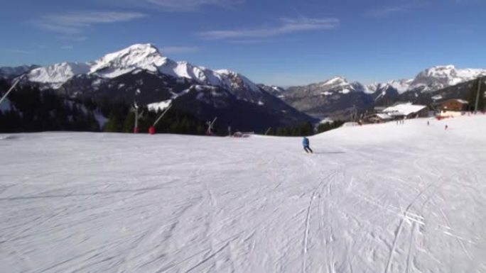 专业滑雪者在瑞士阿尔卑斯山的斜坡上滑雪。展开双手和滑雪。
