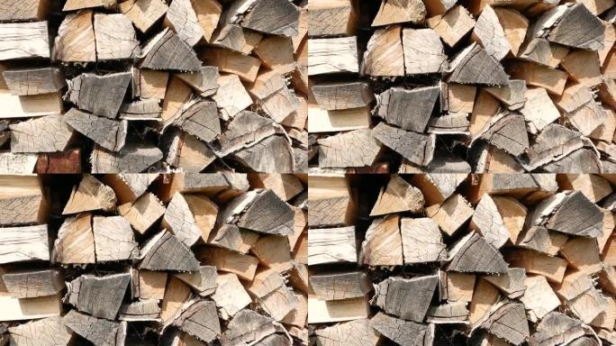 一排排堆积的木柴特写。原木坯料中的燃料。用于加热的天然可燃材料。选择性聚焦