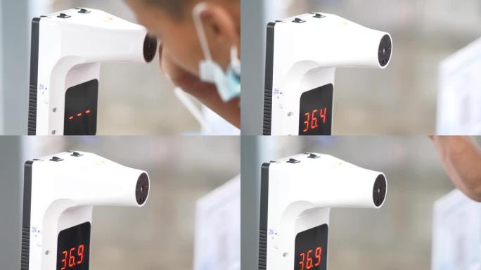 体温测量，年轻的亚洲女性由红外数字温度计检查。用非接触式温度计测量体温的女性。