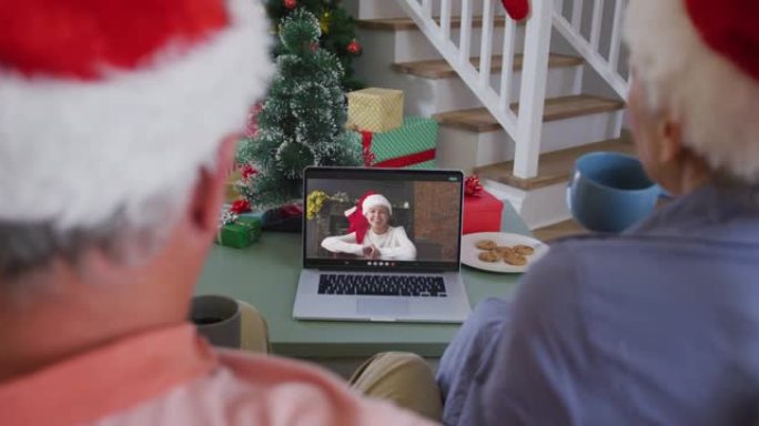 快乐的高级高加索夫妇在圣诞节与孙女在笔记本电脑上进行视频通话