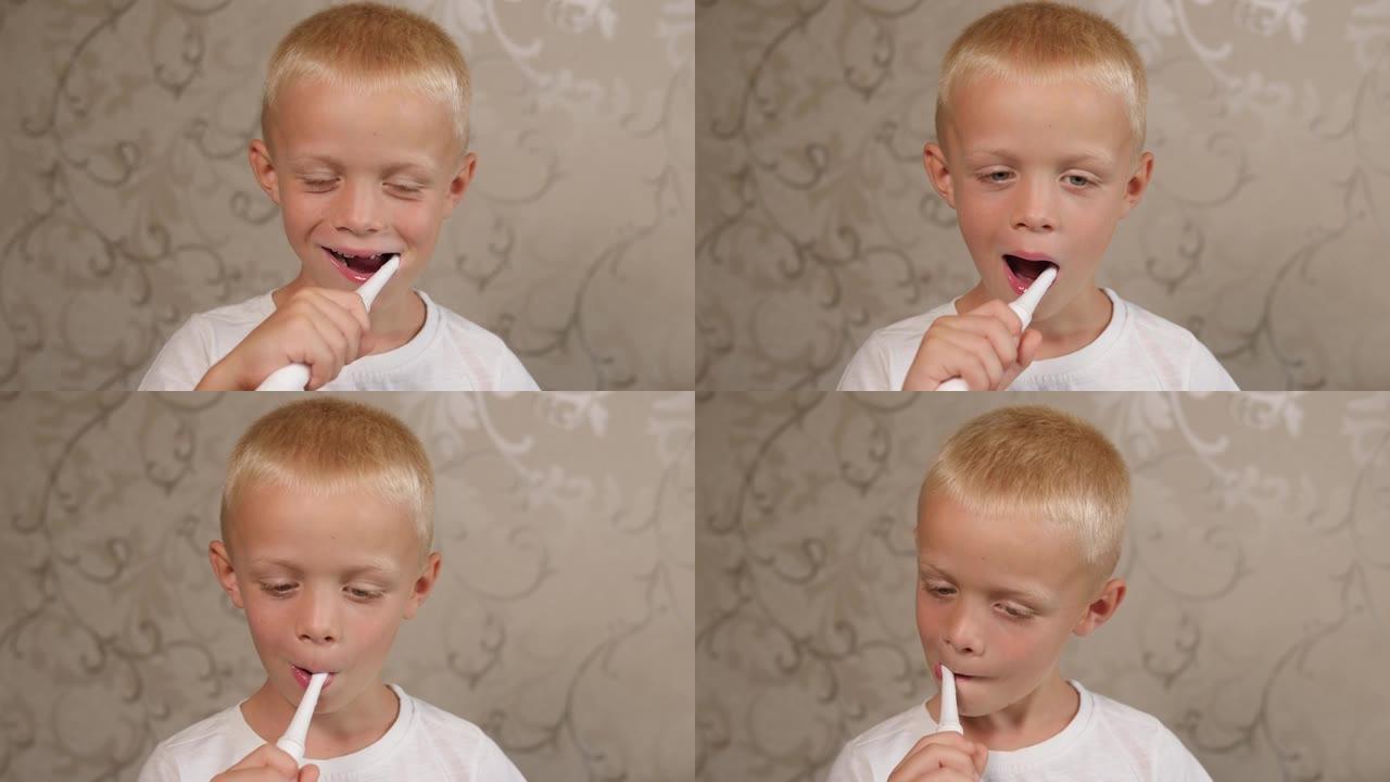 一个快乐的小男孩用电刷刷牙的特写镜头。
