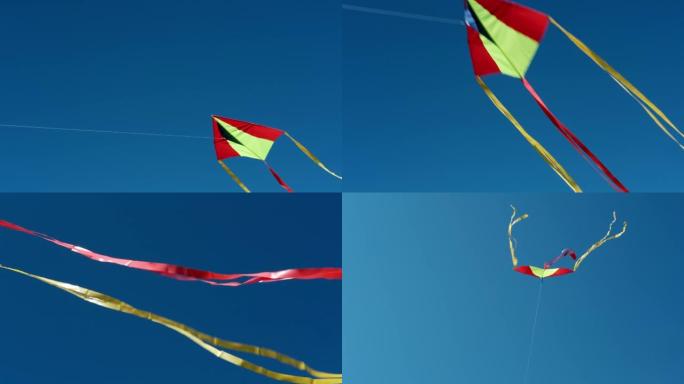 红黄风筝在蔚蓝无云的天空中高高飞翔。缓慢的运动。