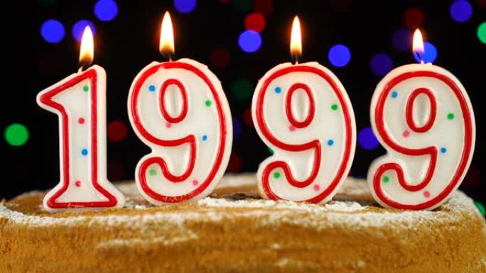 生日蛋糕与白色燃烧的蜡烛在数字1999的形式