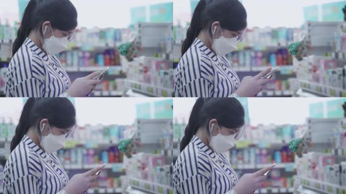 戴口罩的亚洲少女在超市散步买菜
