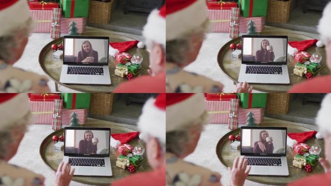 白人高级夫妇使用笔记本电脑与屏幕上的幸福女人进行圣诞节视频通话