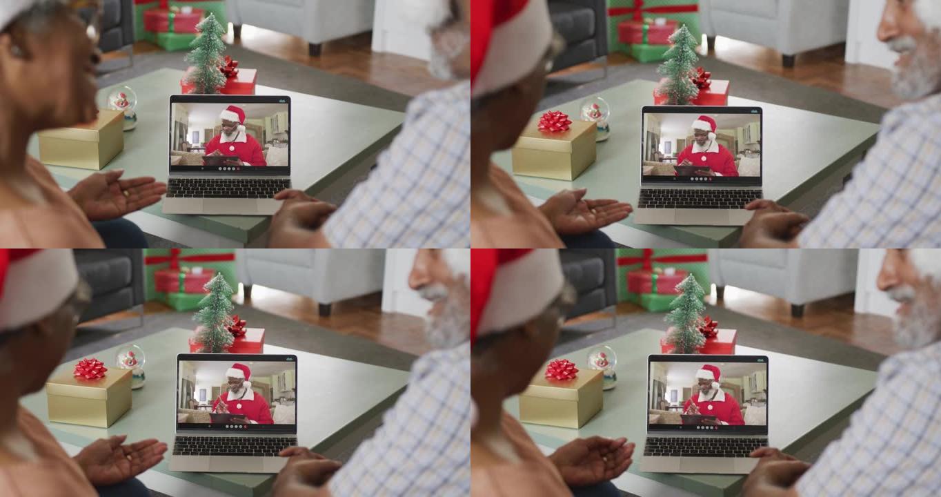 快乐的非洲裔美国高级夫妇在圣诞节与圣诞老人进行视频通话