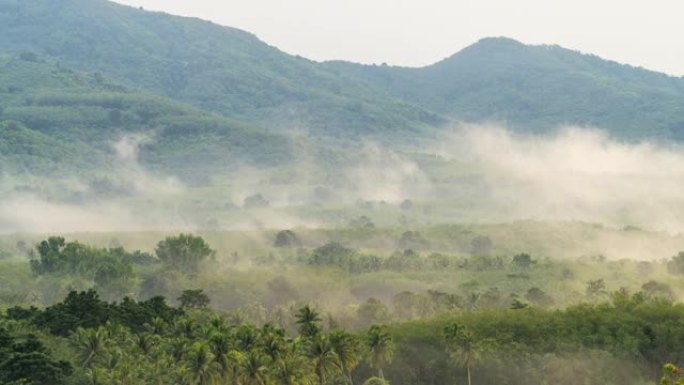泰国宋卡府jana区Liwong村日出时山上的延时雾和阳光穿过云层