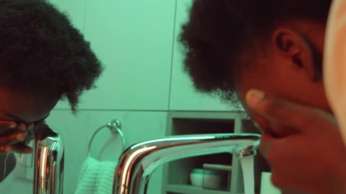 非裔美国妇女在浴室洗脸