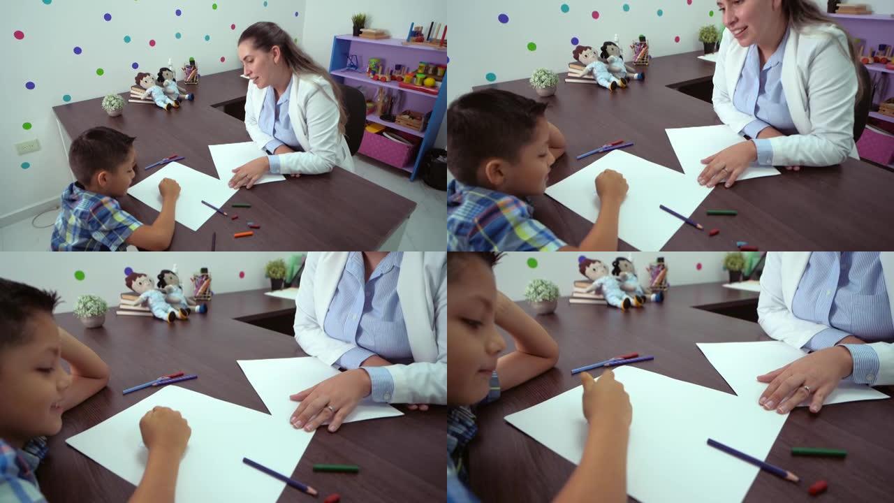 小男孩在心理学家的治疗中绘画和着色