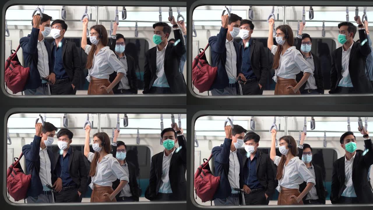 一群戴着外科口罩的多元化人站在一起挤在地铁里。冠状病毒或新型冠状病毒肺炎大流行的公共交通新常态
