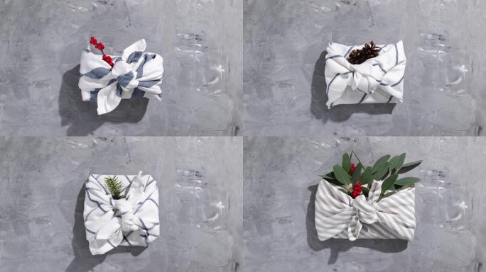 传统日本furoshiki风格的零浪费礼品包装在灰色背景上。圣诞节和其他节日场合的无塑料手工礼包。停