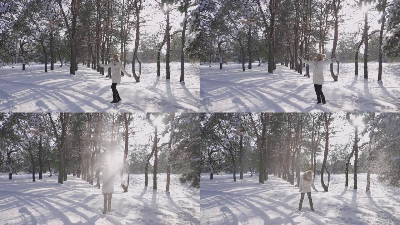 穿着冬装和保暖连指手套的女孩正穿过白雪覆盖的松林，非常高兴。微笑的女性扔雪在阳光下闪闪发光。寒冷的冬