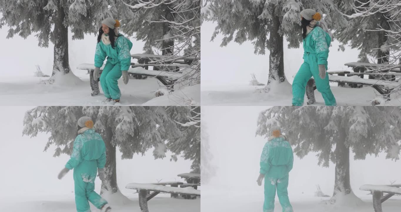 在户外寒假期间，穿着滑雪服的女人在白雪皑皑的森林里