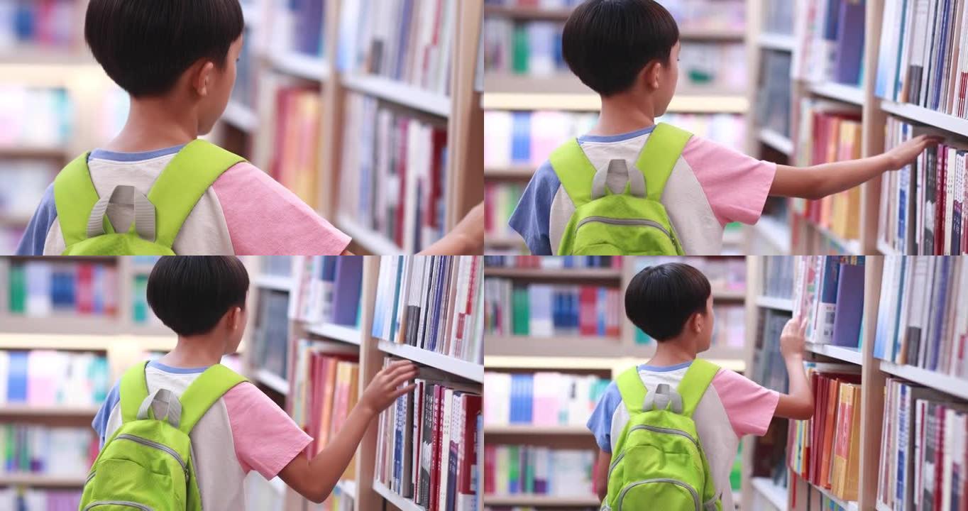 快乐的亚洲孩子在图书馆读书