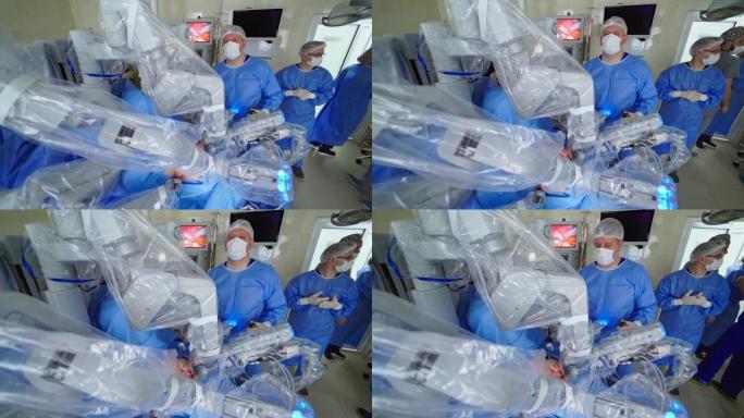 用机器人设备进行手术。医疗团队观察现代诊所中医疗机器人的操作。微创机器人操作。