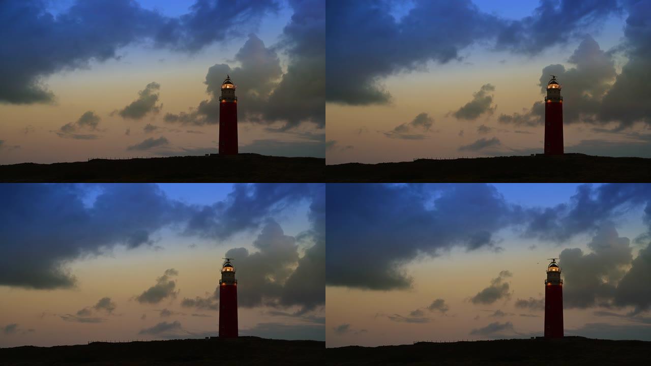 暴风雨的秋天过后，日落期间沙丘中瓦登岛特塞尔的灯塔