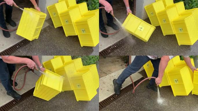 女人洗黄色的塑料盒