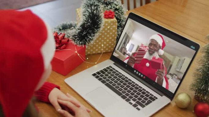 快乐的白人妇女在圣诞节与圣诞老人进行视频通话