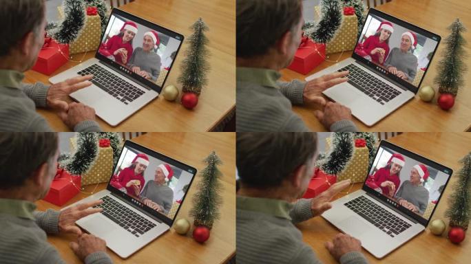 快乐的高加索高级男子在圣诞节与高级朋友进行视频通话