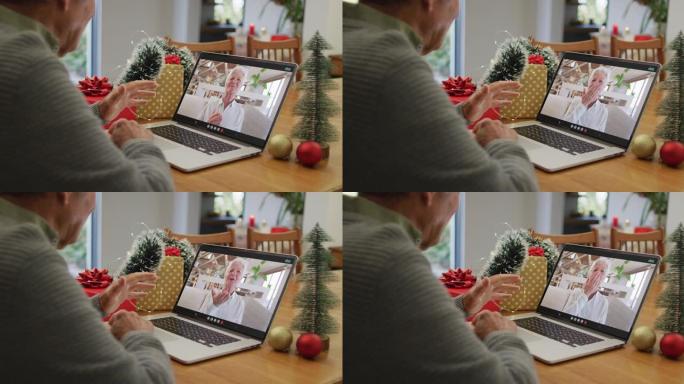快乐的高加索高级男子在圣诞节与高级女性朋友在笔记本电脑上进行视频通话