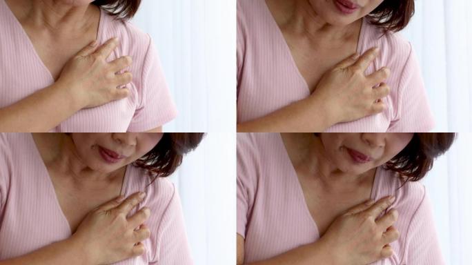 一名高级妇女因心脏病发作而痛苦不堪，用手握胸部放在心脏位置。老年人保健的概念。