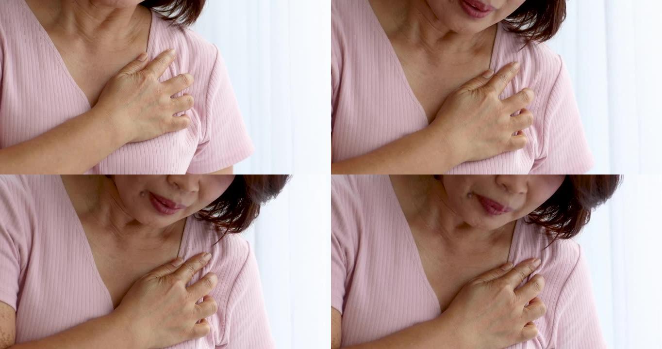 一名高级妇女因心脏病发作而痛苦不堪，用手握胸部放在心脏位置。老年人保健的概念。