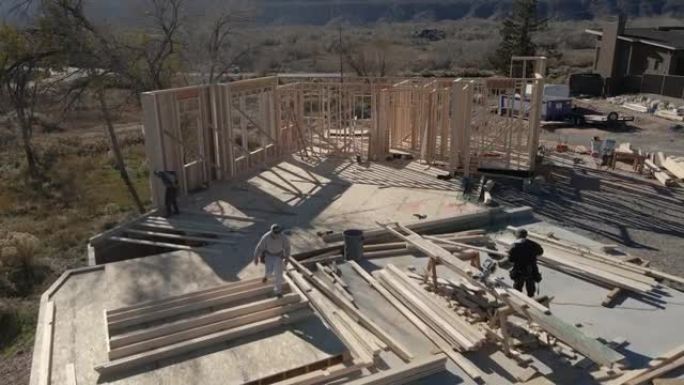 无人机家庭建筑工地，三名高加索框架木匠正在建造墙壁
