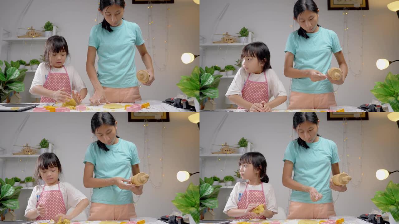 快乐的亚洲儿童在家学习制作饼干，女孩一起打谷糕点面团，生活方式理念。