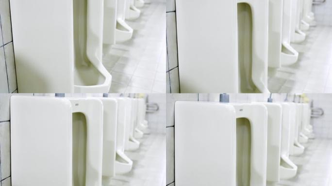 现代建筑中的男厕所。从下到上倾斜镜头。厕所的外观非常干净。