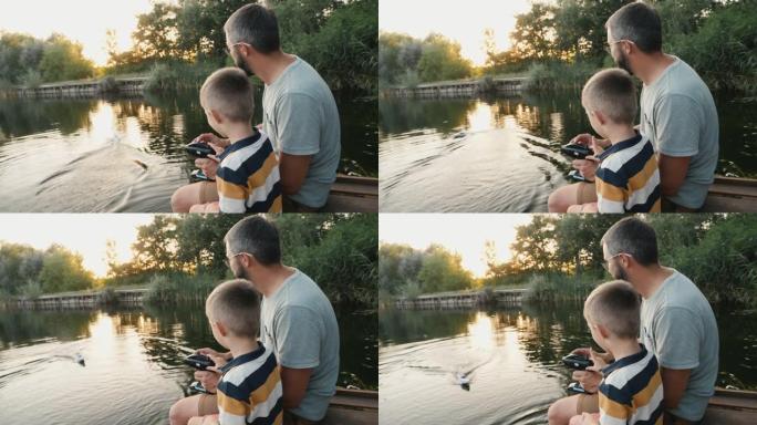 父亲和小儿子在湖上玩RC玩具快艇