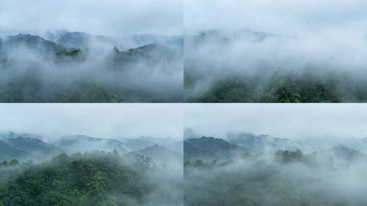 在夏季阴天的日出场景中，云在山上流过的时间流逝