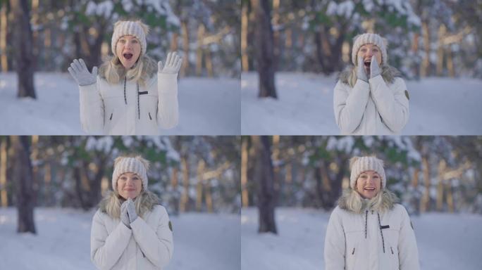 穿着暖和的冬装的可爱女孩的肖像看着相机，带着惊喜和惊喜。年轻女子在白雪皑皑的森林模糊背景下在户外摆姿