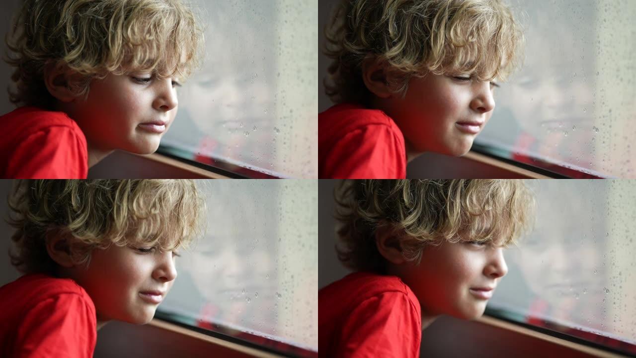 泪流满面的孩子想出去，下雨天男孩在窗户旁