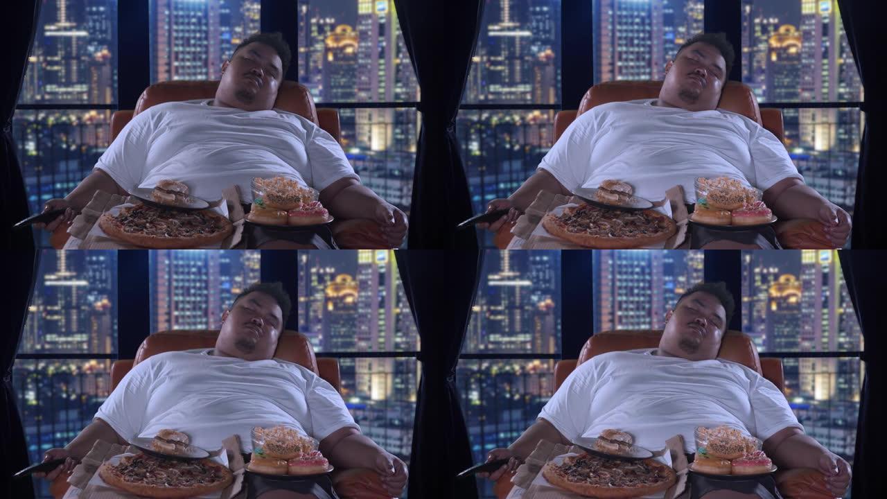 肥胖男子在公寓里用垃圾食品睡觉