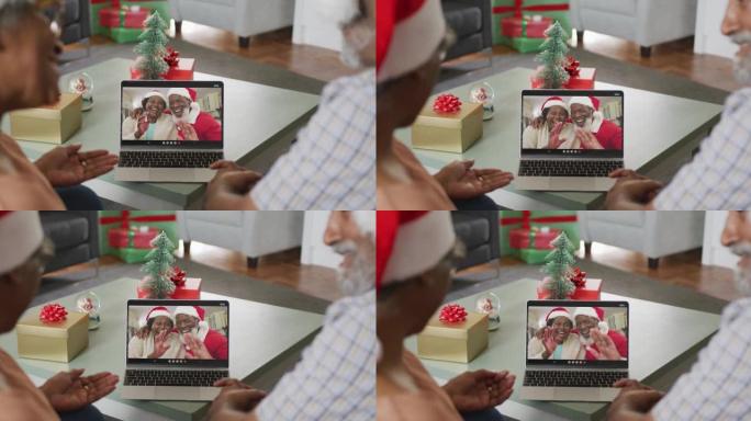 快乐的高级非洲裔美国夫妇在圣诞节与朋友进行视频通话