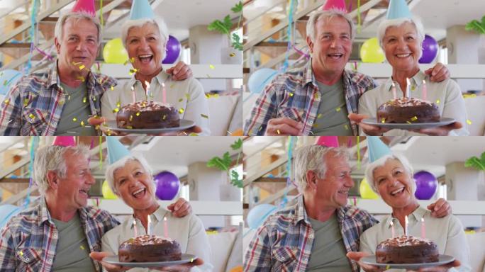 戴着派对帽的快乐高加索高级夫妇用蛋糕和金色五彩纸屑做生日视频通话