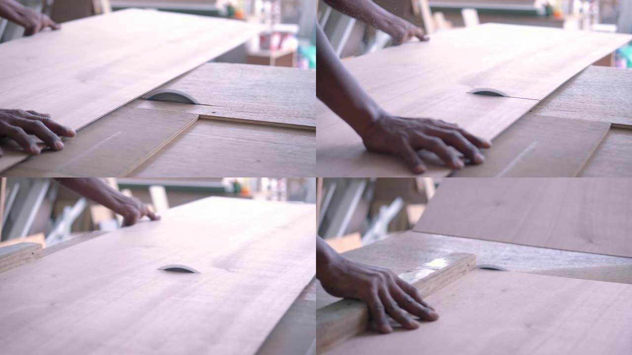 木匠使用电锯徒手切割木材以制造具有专业知识但不佩戴安全设备的内置橱柜可能会造成伤害