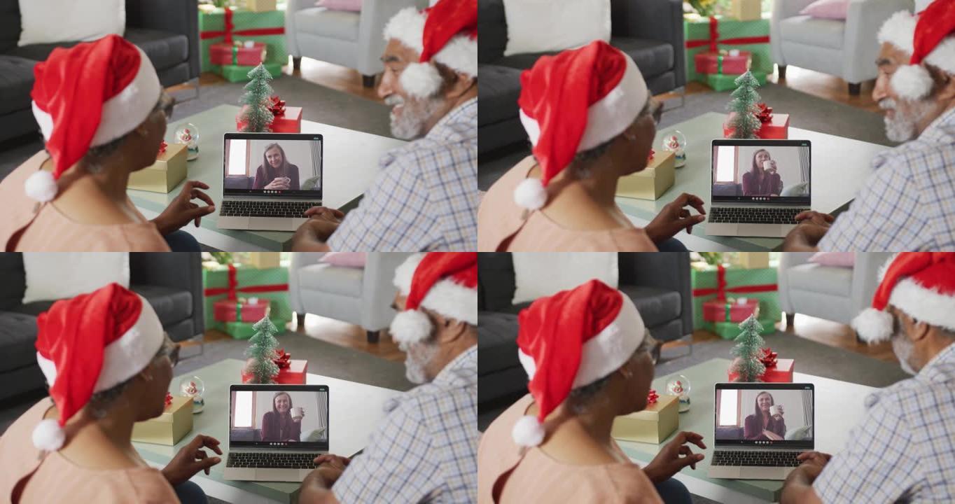 圣诞节时，与女性朋友在笔记本电脑上视频通话的快乐非裔美国夫妇