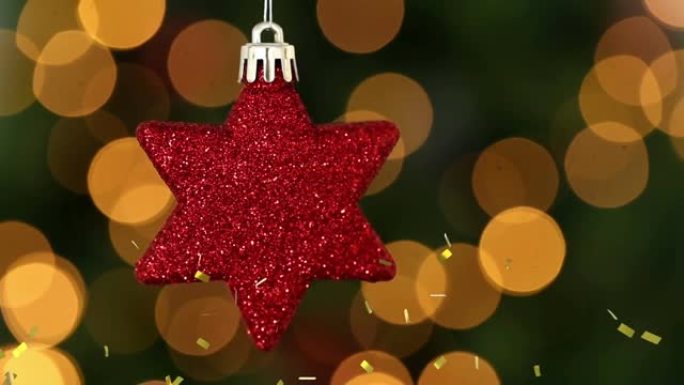 金色五彩纸屑掉落在红星圣诞树装饰上的动画，后面有bokeh灯