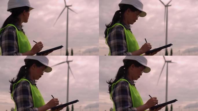 由女工程师检查的风力涡轮机。