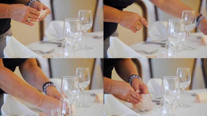 装饰者正在为餐厅的婚礼装饰带有姓名标签的桌子