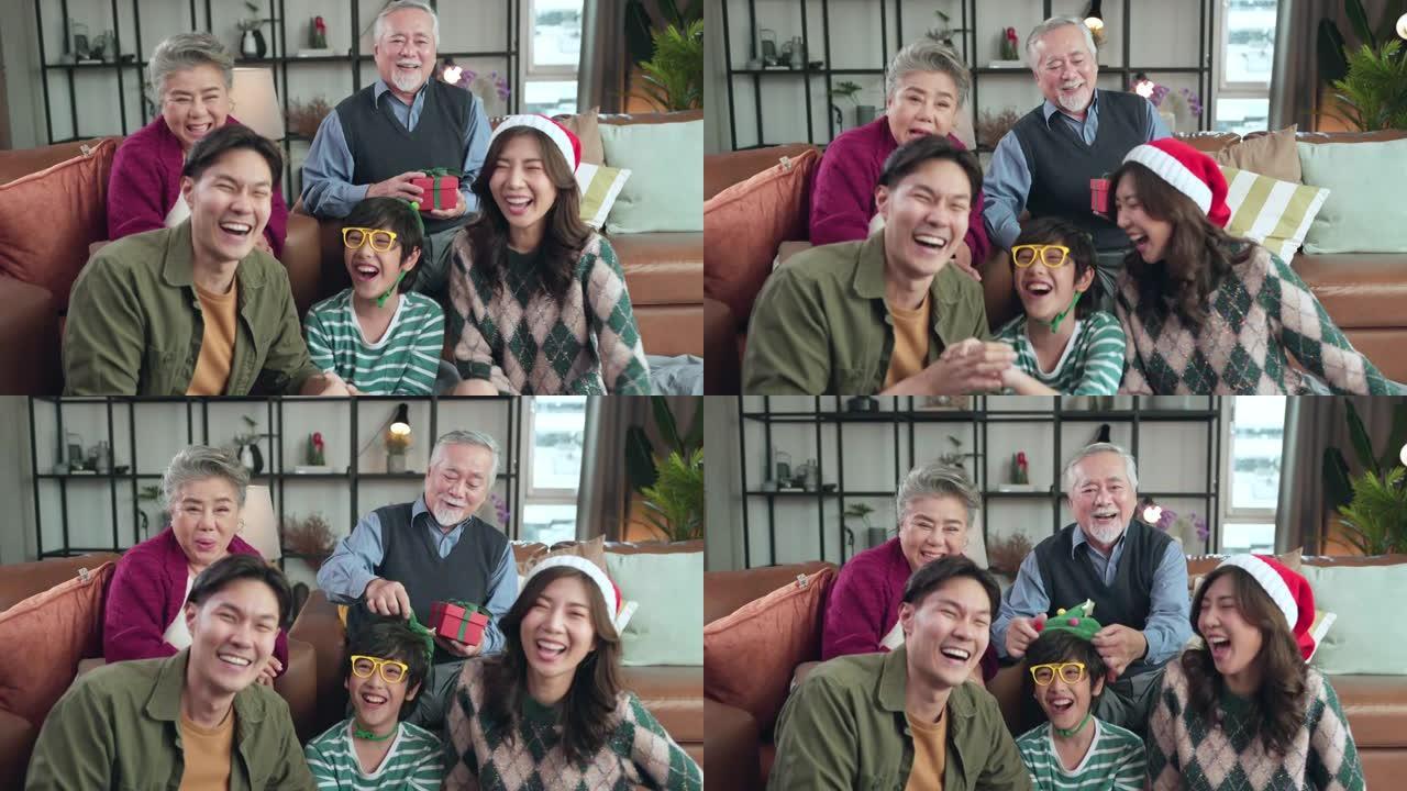 幸福圣诞感恩节周末，多代亚洲家庭拜访祖父母坐在一起放松笑笑有趣快乐美好的时刻客厅在家里，pov亚洲家