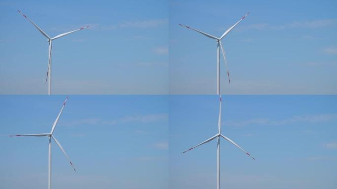 风力涡轮机旋转，在蓝天下产生能量