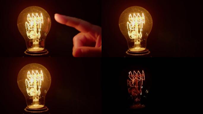 黑色背景上的人的手的手指触摸使灯泡亮起。人类互动与新技术概念