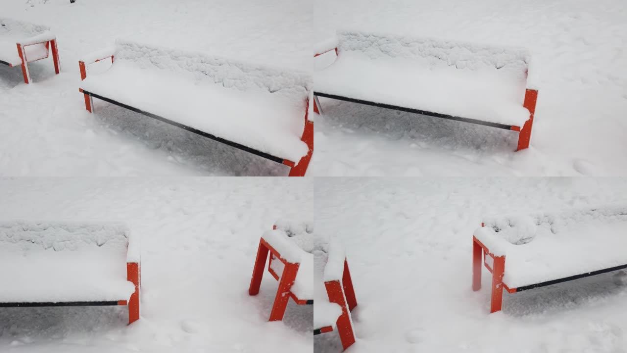 冬季公园里积雪覆盖的长凳。