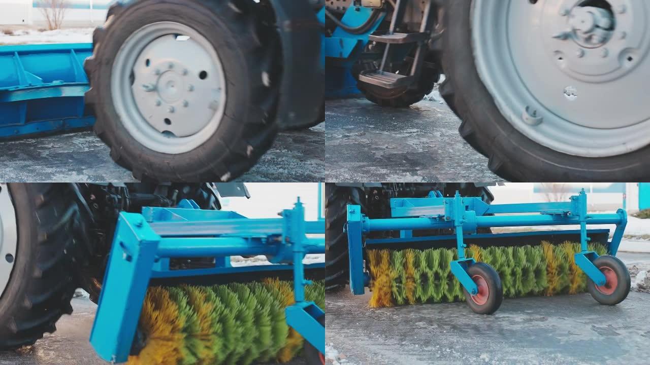 带铲子和旋转刷子的轮式拖拉机清洁街道上的积雪和污垢。慢动作视频