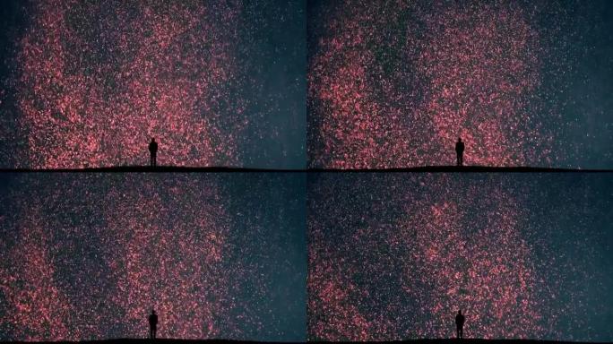 这个人站在下落的微光背景上