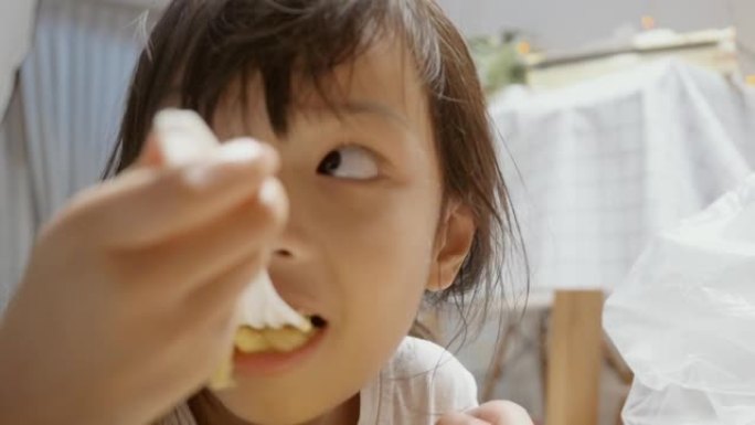 亚洲女孩晚上在家吃意大利面和大蒜面包，生活方式概念。
