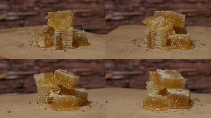 金色的蜂巢被切成块，然后在木板上旋转。蜂蜜从蜂窝中滴落。健康食品概念。家庭养蜂场的生态天然食品